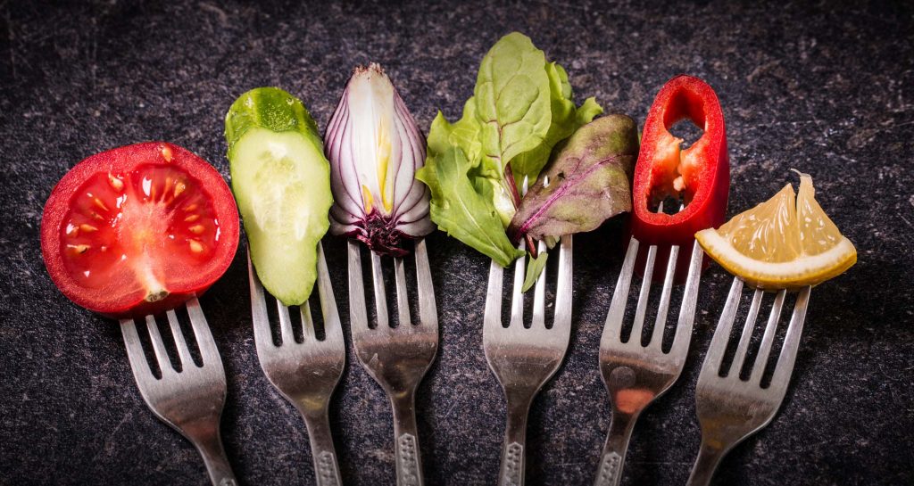 various vegetables on forks