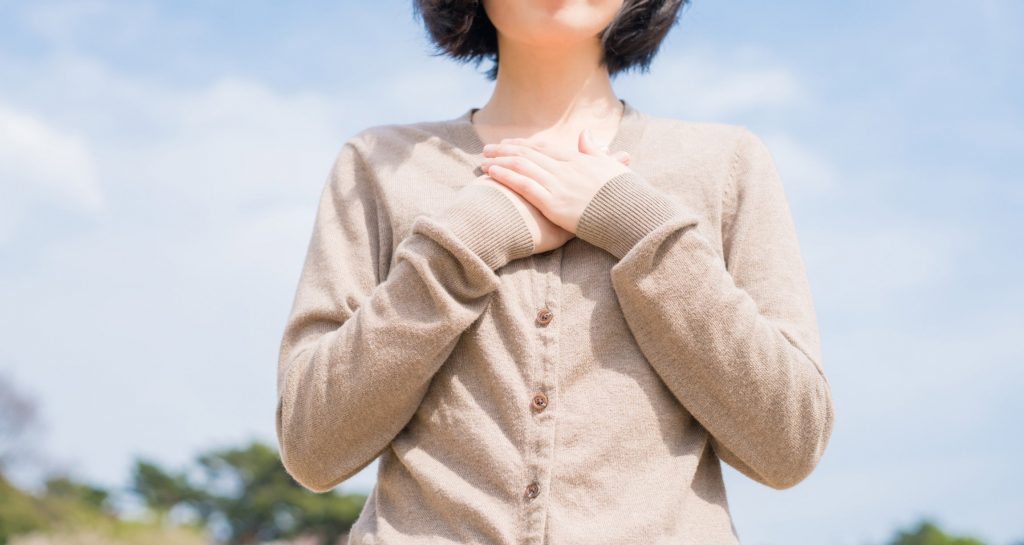 woman with hands over heart