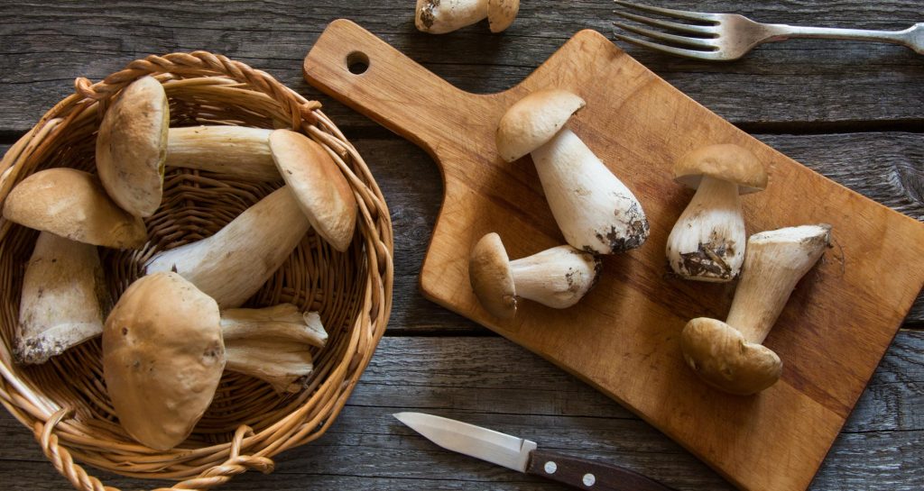 mushrooms in a bowl and on cutting board