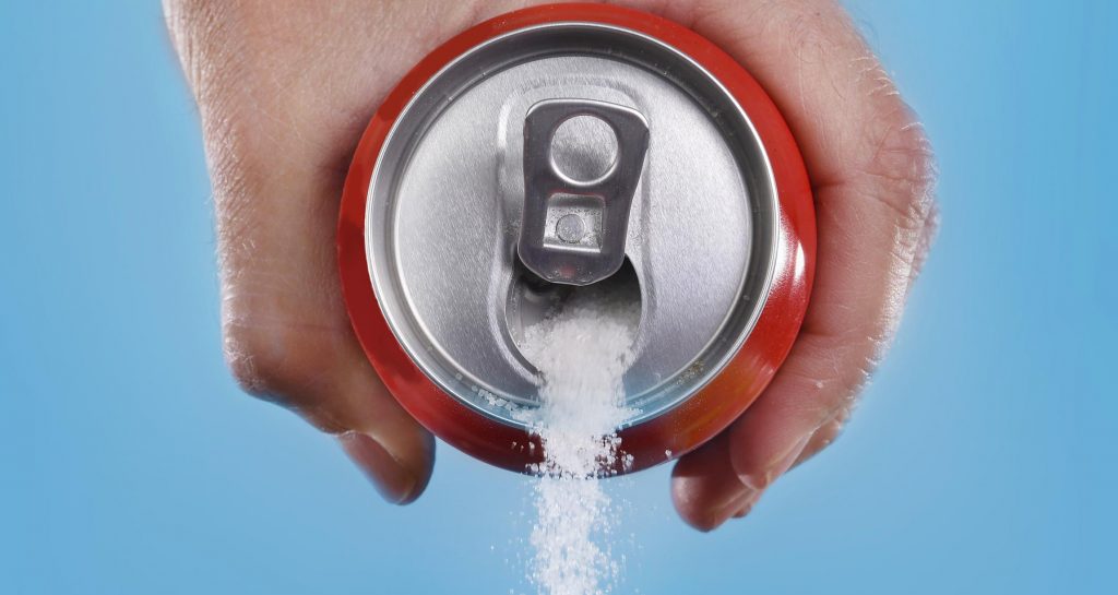 soda can with sugar pouring out
